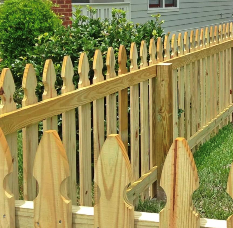 Pressure treated wood picket fence